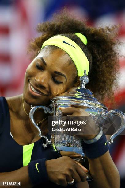 Serena Williams of the United States hugs the championship trophy after defeating Victoria Azarenka of Belarus to win the women's singles final match...