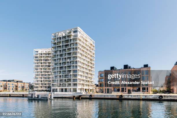 modern apartment buildings by the waterfront in copenhagen, denmark - copenhagen harbour stock pictures, royalty-free photos & images