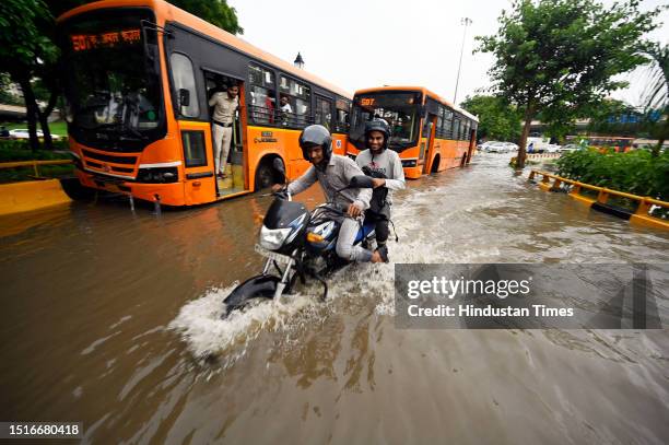 Commuters move through a waterlogged road at AIIMS after monsoon rain, on July 9, 2023 in New Delhi, India. Delhi-NCR was drenched with heavy rain on...