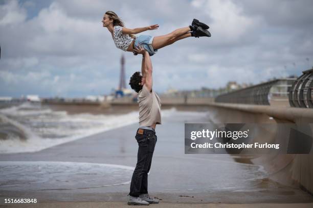 Michael O’Reilly and Kira Malou pose for the media as they perform 'the lift' from Dirty Dancing on Blackpool Promenade on July 05, 2023 in...