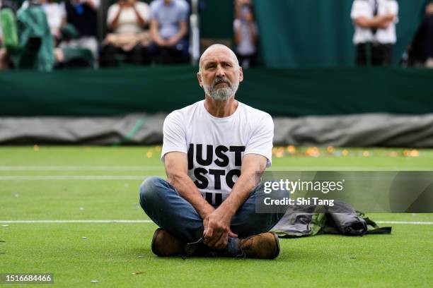 Protester interrupts the Men's Singles first round match between Sho Shimabukuro of Japan and Grigor Dimitrov of Bulgaria during day three of The...