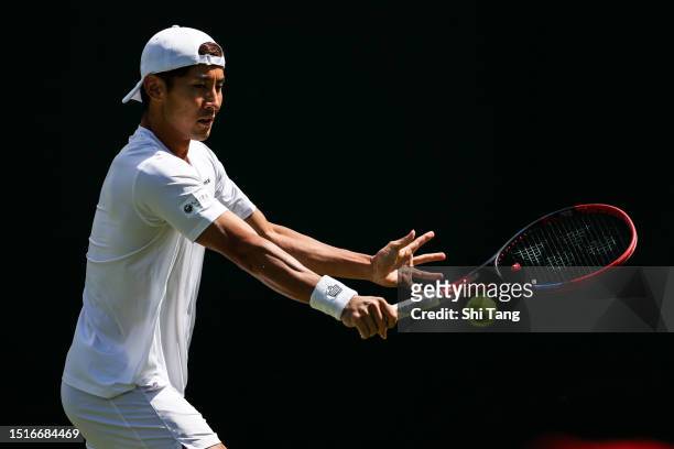 Sho Shimabukuro of Japan plays a backhand in the Men's Singles first round match against Grigor Dimitrov of Bulgaria during day three of The...