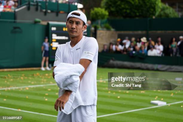 Sho Shimabukuro of Japan reacts after protesters interrupted the Men's Singles first round match between Sho Shimabukuro of Japan and Grigor Dimitrov...