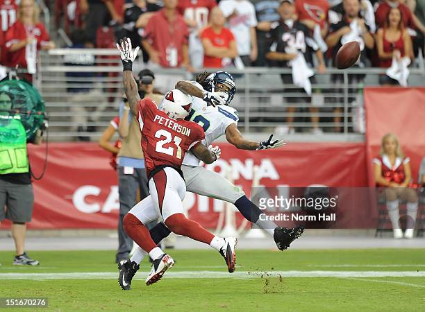 Sidney Rice of the Seattle Seahawks is tackled before the pass gets to him by Patrick Peterson of the Arizona Cardinals at University of Phoenix...