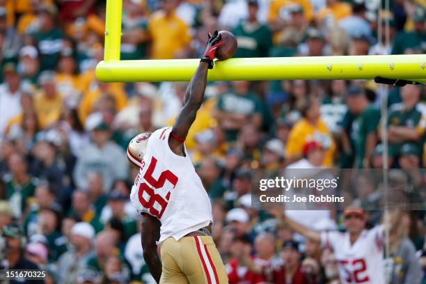 Vernon Davis of the San Francisco 49ers dunks the football over the goal post after catching a four-yard touchdown pass in the third quarter of the...