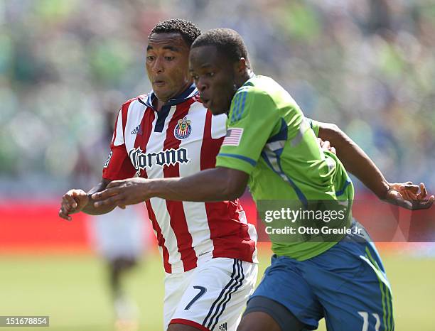 James Riley of Chivas USA battles Steve Zakuani of the Seattle Sounders FC at CenturyLink Field on September 8, 2012 in Seattle, Washington. The...