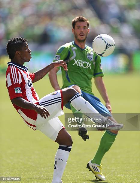 Miller BolaÃ±os of Chivas USA controls the ball against Brad Evans of the Seattle Sounders FC at CenturyLink Field on September 8, 2012 in Seattle,...