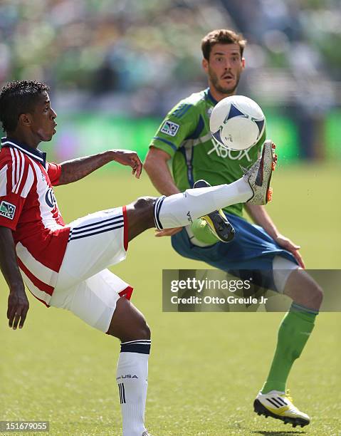 Miller BolaÃ±os of Chivas USA controls the ball against Brad Evans of the Seattle Sounders FC at CenturyLink Field on September 8, 2012 in Seattle,...