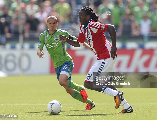 Shalrie Joseph of Chivas USA dribbles against Osvaldo Alonso of the Seattle Sounders FC at CenturyLink Field on September 8, 2012 in Seattle,...