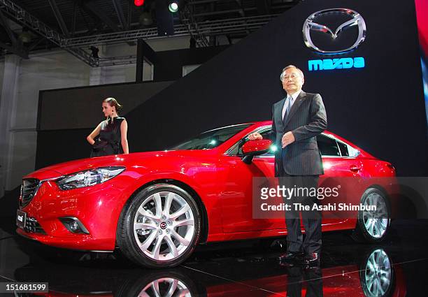Mazda Motor Corporation CEO and President Takashi Yamanouchi poses for photographs with their new model 'Mazda 6' during the Moscow International...