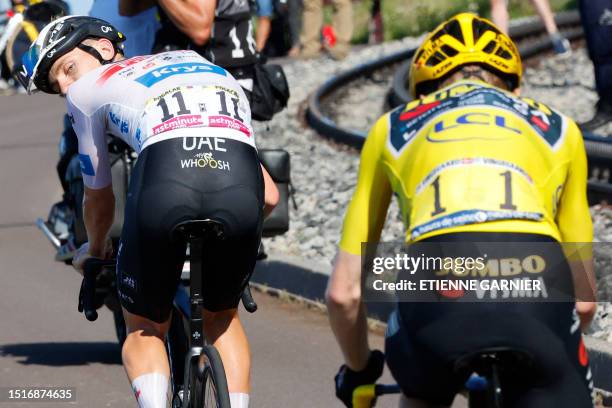 Team Emirates' Slovenian rider Tadej Pogacar wearing the best young rider's white jersey cycles ahead of Jumbo-Visma's Danish rider Jonas Vingegaard...