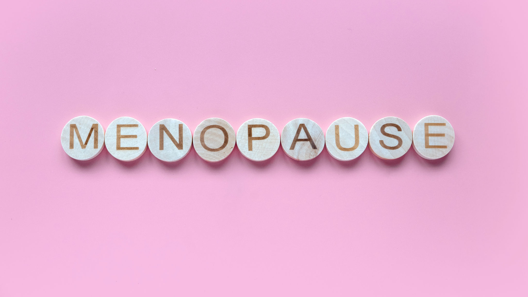 Alphabet form a word menopause. Healthcare and medical concept for women. Pink background. Alphabet form a word menopause. Healthcare and medical concept for women. Pink background.