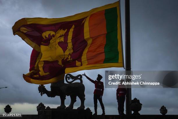 Military personnel lower the national flag of Sri Lanka at dusk at Galle Face Green on July 05, 2023 in Colombo, Sri Lanka.