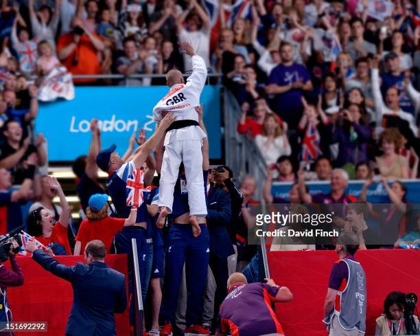 Ben Quilter of Great Britain is raised high in the air by his team mates to celebrate his u60kgs bronze medal victory during Day 1 of the London 2012...