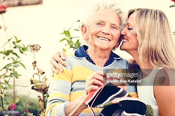 elderly woman knitting - all you need is love stockfoto's en -beelden