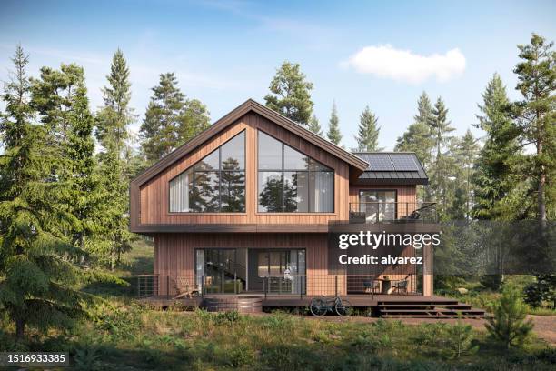 3d-rendering eines hölzernen waldhauses, umgeben von bäumen - house roof materials stock-fotos und bilder