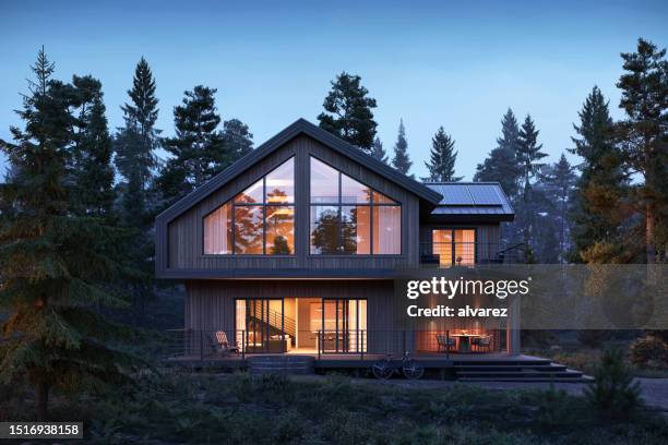 3d render of forest house with large windows at night - luxury apartment windows exterior stock pictures, royalty-free photos & images