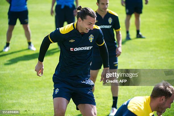 Sweden national football team's player Zlatan Ibrahimovic laughs during a training session with the Swedish team in Malmo on September 10, 2012....