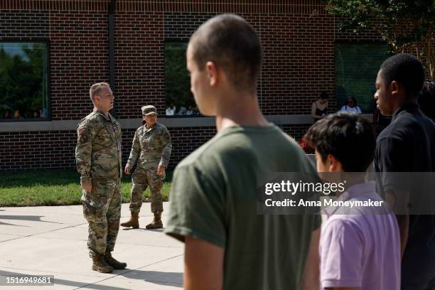 Military recruits practice taking the oath of enlistment before a ceremony with U.S. Secretary of Defense Lloyd Austin at Fort George G. Meade on...