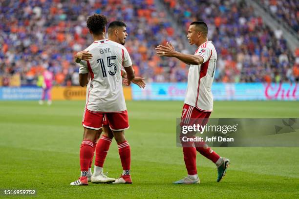 Gustavo Bou, Brandon Bye and Bobby Wood of New England Revolution celebrate following an own-goal by Dominique Badji of FC Cincinnati during a MLS...