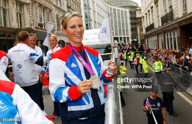 British Olympic silver medal winning equestrian athlete Zara Phillips holds her Three Day Event silver medal as he takes part in the parade passing...