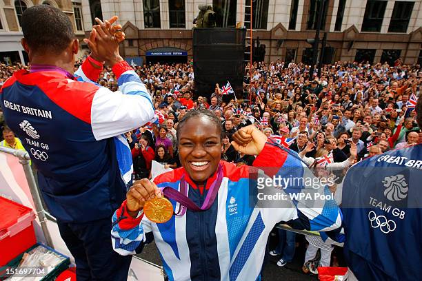 British Olympic gold medal winning boxer Nicola Adams smiles as she holds her medal during the London 2012 Victory Parade for Team GB and Paralympic...