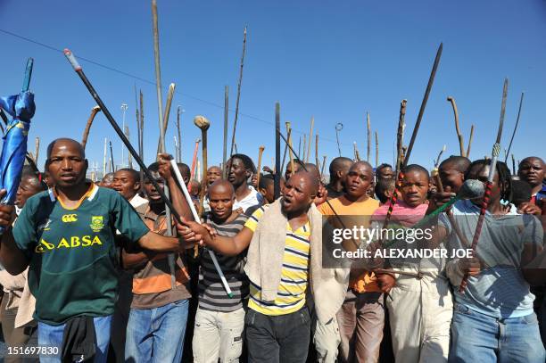 Thousands of South African mine workers walk on September 10, 2012 to the Lonmin mine in Marikana to try and stop other miners from going to work....