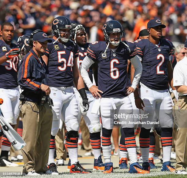 Quaterbacks coach Jeremy Bates, Brian Urlacher, Jay Cutler and Jason Campbell of the Chicago Bears watch from the sidelines against the Indianapolis...