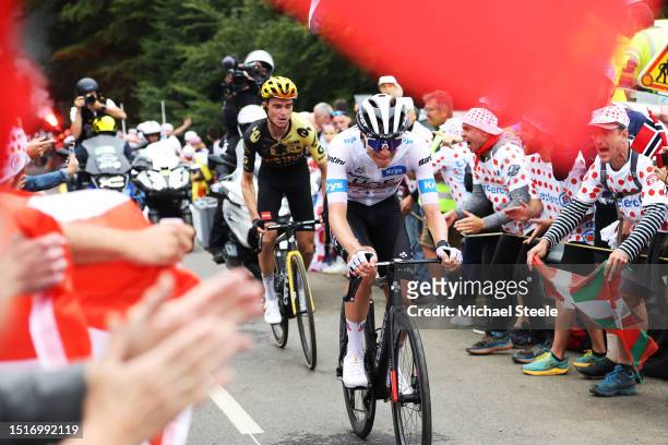 Sepp Kuss of The United States and Team Jumbo-Visma and Tadej Pogacar of Slovenia and UAE Team Emirates - White best young jersey compete while fans...