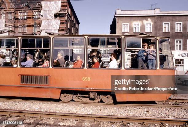 Passengers board a tram running along a street in the centre of the city of Katowice in Silesia Province of southern Poland in 1989.