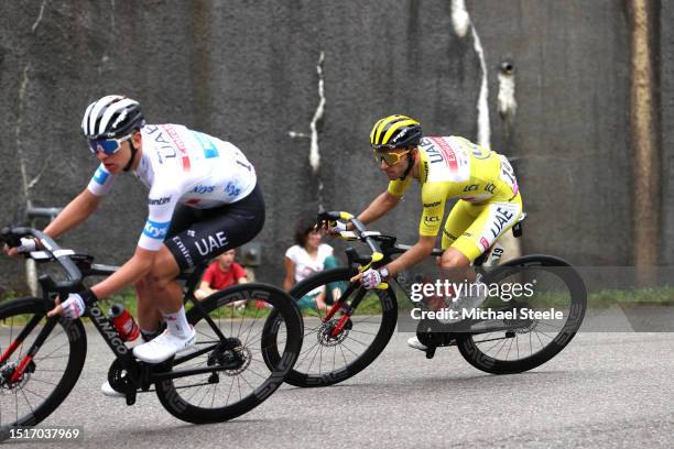 Tadej Pogacar of Slovenia - White best young jersey and Adam Yates of United Kingdom and UAE Team Emirates - Yellow leader jersey compete during the...