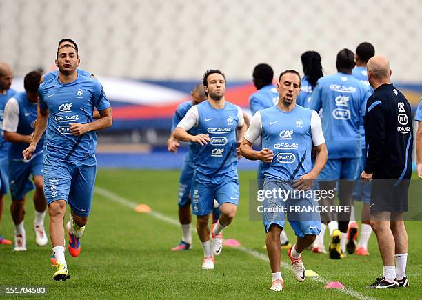 French forward Karim Benzema, midfielder Mathieu Valbuena and forward Franck Ribery warm up during a French team training session, on September 10,...