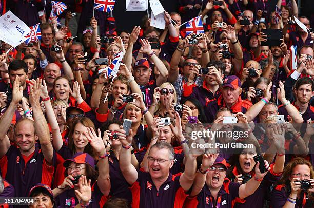 Volunteers and Games Makers take part in the London 2012 Victory Parade for Team GB and Paralympics GB athletes through central London on September...