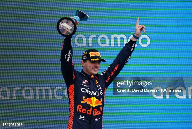 Red Bull's Max Verstappen celebrates with his trophy for first on the podium after the British Grand Prix 2023 at Silverstone, Towcester. Picture...