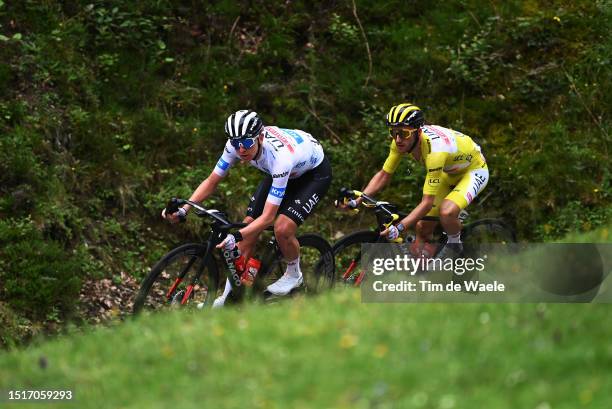 Tadej Pogacar of Slovenia - White best young jersey and Adam Yates of United Kingdom and UAE Team Emirates - Yellow leader jersey compete during the...