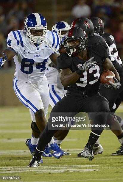 Stepfan Taylor of the Stanford Cardinal breaks the arm tackle of Kenny Anunike of the Duke Blue Devils during the first quarter of an NCAA football...