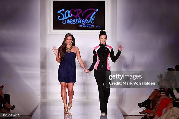 Personality and fashion designer Sammi 'Sweetheart' Giancola walks the runway with a model during the Sammi Sweetheart Spring 2013 fashion show at...