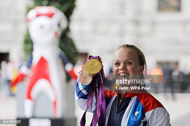 Paralympics GB gold medallist swimmer Ellie Simmonds poses with her medals before attending a reception for Team GB and Paralympic GB athletes,...