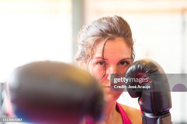 woman practicing kickboxing - mixed martial arts woman stock pictures, royalty-free photos & images