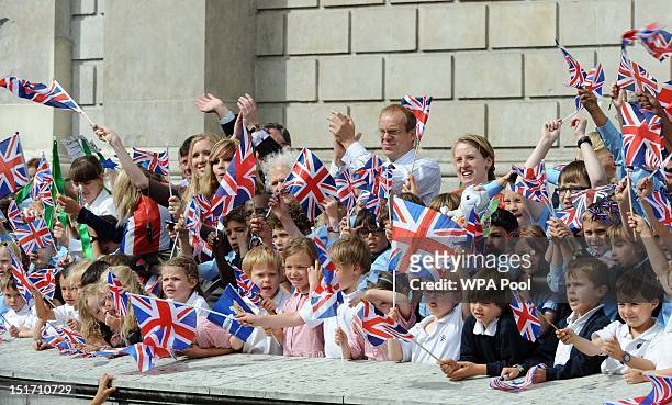 Members of the public cheer on the athletes as they take part in the London 2012 Victory Parade for Team GB and Paralympic GB athletes on September...