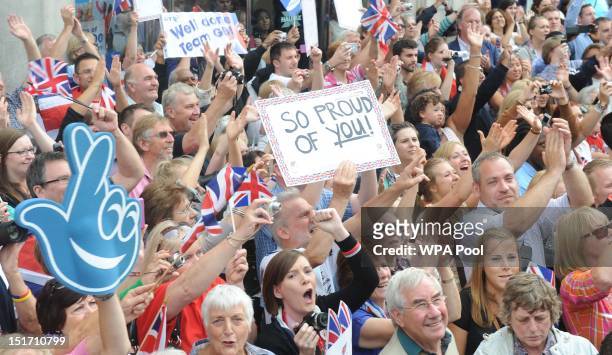 Members of the public cheer on the athletes as they take part in the London 2012 Victory Parade for Team GB and Paralympic GB athletes on September...