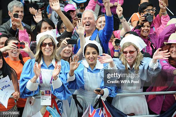 Members of the public cheer on the athletes as they take part in the London 2012 Victory Parade for Team GB and Paralympic GB athletes on September...