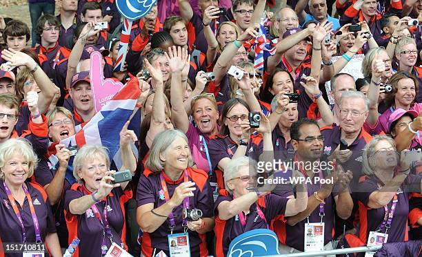 Volunteers and Games Makers cheer on the athletes as they take part in the London 2012 Victory Parade for Team GB and Paralympic GB athletes on...