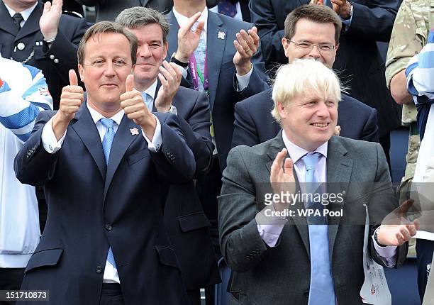 Prime Minister David Cameron and Mayor of London Boris Johnson cheer on the athletes as they take part in the London 2012 Victory Parade for Team GB...