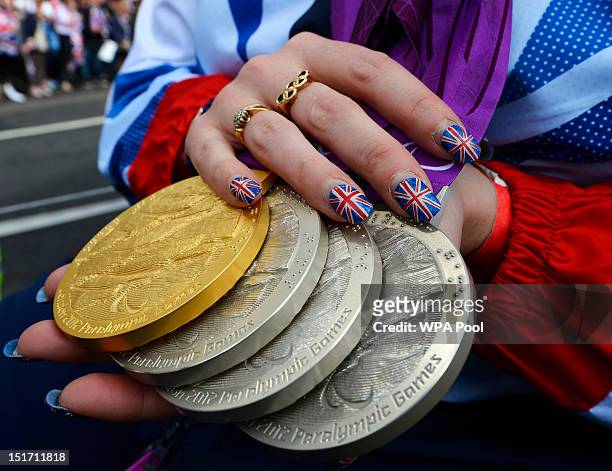 Paralympics GB swimmer Heather Frederiksen holds her gold and silver medals during the London 2012 Victory Parade for Team GB and Paralympics GB...