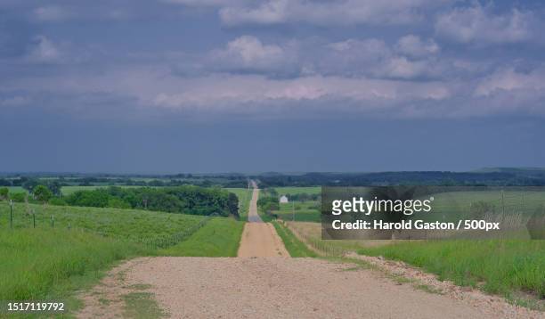 empty road amidst field against sky,kansas,united states,usa - v kansas stock pictures, royalty-free photos & images