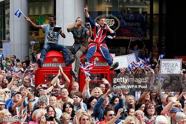 Spectators watch a parade during the London 2012 Victory Parade for Team GB and Paralympic GB athletes on September 10, 2012 in London, England.