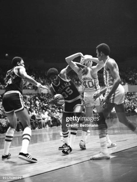 The Indiana Pacers Roger Brown and Mel Daniels play against Andy Anderson and Merv Jackson of the Los Angeles Stars during the sixth and final game...