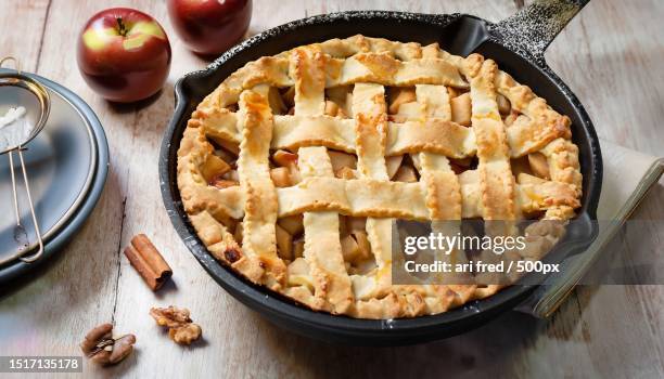 high angle view of apple pie on table - apfelkuchen stock-fotos und bilder