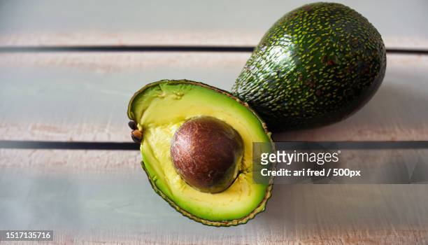 close-up of avocados on table - abocado fotografías e imágenes de stock